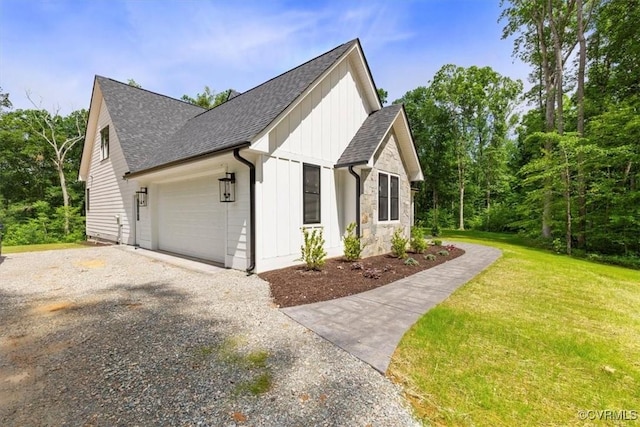 343 Petersburg Rd, Powhatan, VA 23139 - view of side of home featuring board and batten siding, driveway, an attached garage, a shingled roof, and a yard