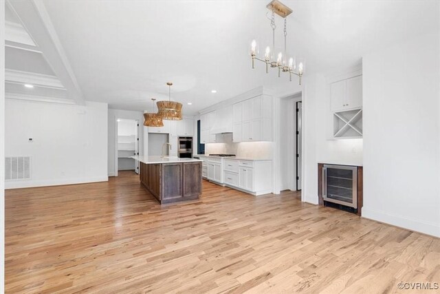 343 Petersburg Rd, Powhatan, VA 23139 - kitchen featuring wine cooler, a chandelier, light wood-type flooring, light countertops, and recessed lighting
