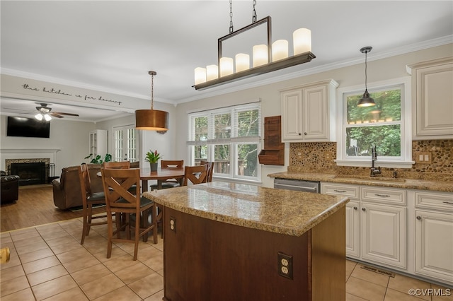 7727 Centerbrook Ct, Chesterfield, VA 23832 - kitchen with a sink, light tile patterned floors, a kitchen island, a fireplace, and pendant lighting