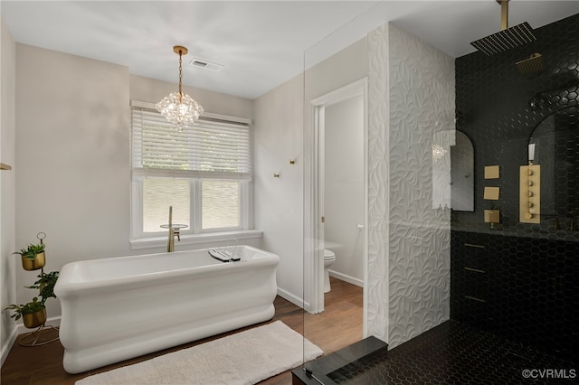 7727 Centerbrook Ct, Chesterfield, VA 23832 - bathroom with wood finished floors, baseboards, a freestanding bath, and a chandelier