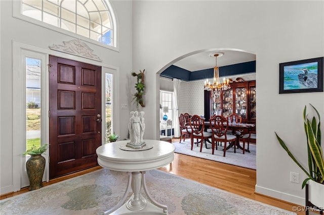 5225 Clipper Cove Rd, Chesterfield, VA 23112 - foyer entrance featuring arched walkways, wood finished floors, a chandelier, a towering ceiling, and baseboards