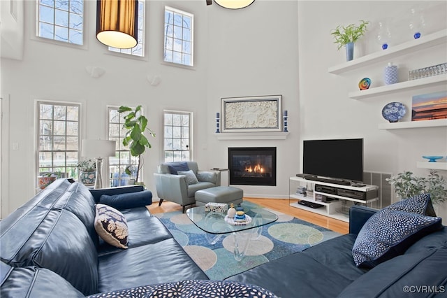 5225 Clipper Cove Rd, Chesterfield, VA 23112 - living room with wood finished floors, a glass covered fireplace, plenty of natural light, and a towering ceiling