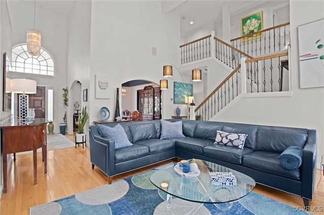 5225 Clipper Cove Rd, Chesterfield, VA 23112 - living room featuring a high ceiling, arched walkways, hardwood / wood-style flooring, and stairs