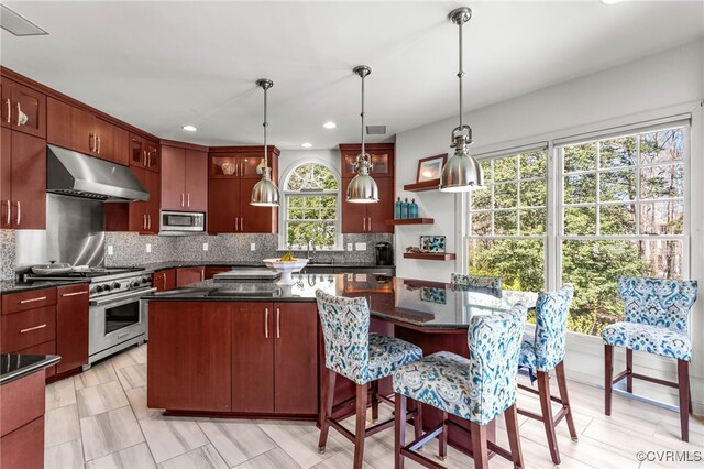 5225 Clipper Cove Rd, Chesterfield, VA 23112 - kitchen featuring appliances with stainless steel finishes, under cabinet range hood, backsplash, a kitchen island, and decorative light fixtures