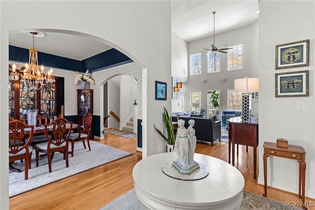 5225 Clipper Cove Rd, Chesterfield, VA 23112 - dining room featuring arched walkways, wood finished floors, stairs, a ceiling fan, and a chandelier