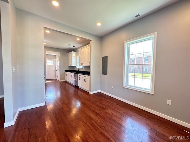 401 N 3 1/2 Ave, Hopewell, VA 23860 - kitchen with dishwasher, electric panel, dark wood-style floors, white cabinetry, and baseboards
