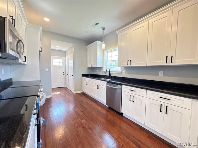 401 N 3 1/2 Ave, Hopewell, VA 23860 - kitchen with appliances with stainless steel finishes, recessed lighting, baseboards, dark wood-style floors, and pendant lighting