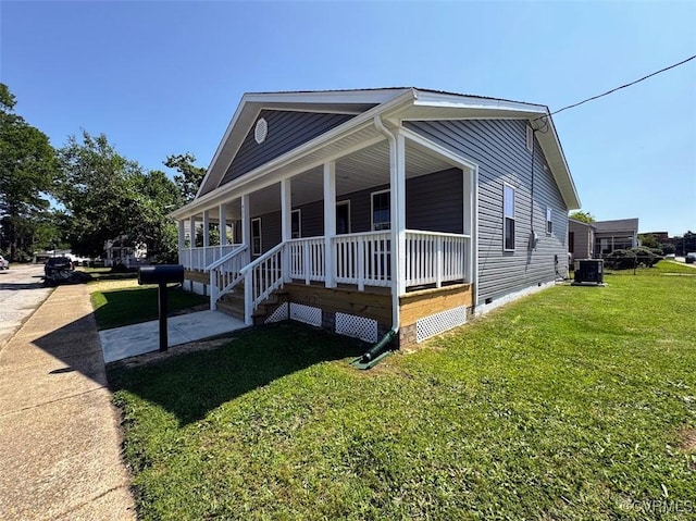 401 N 3 1/2 Ave, Hopewell, VA 23860 - view of front of house featuring crawl space, central AC unit, a front lawn, and covered porch