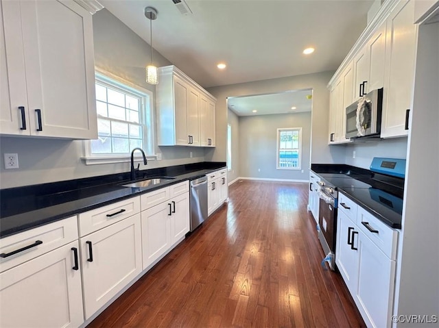 401 N 3 1/2 Ave, Hopewell, VA 23860 - kitchen with stainless steel appliances, a sink, white cabinets, dark countertops, and recessed lighting