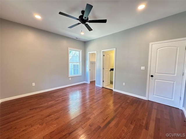 401 N 3 1/2 Ave, Hopewell, VA 23860 - unfurnished bedroom with dark wood finished floors, baseboards, a walk in closet, recessed lighting, and ceiling fan