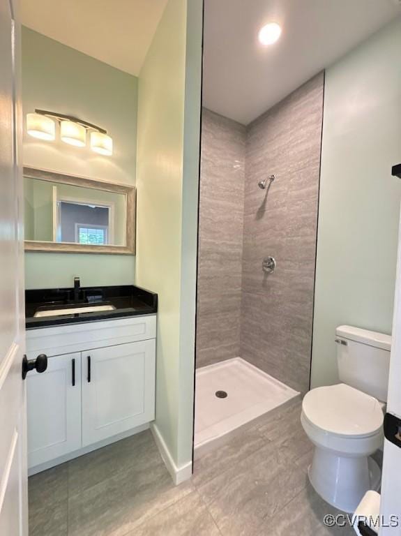 401 N 3 1/2 Ave, Hopewell, VA 23860 - full bathroom featuring tiled shower, vanity, toilet, and tile patterned floors