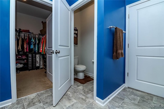 7547 Sedge Dr, New Kent, VA 23124 - bathroom with a walk in closet and stone finish flooring