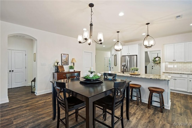 15719 Henningford Rd, Chesterfield, VA 23832 - dining space featuring arched walkways, dark wood-style floors, baseboards, a chandelier, and recessed lighting