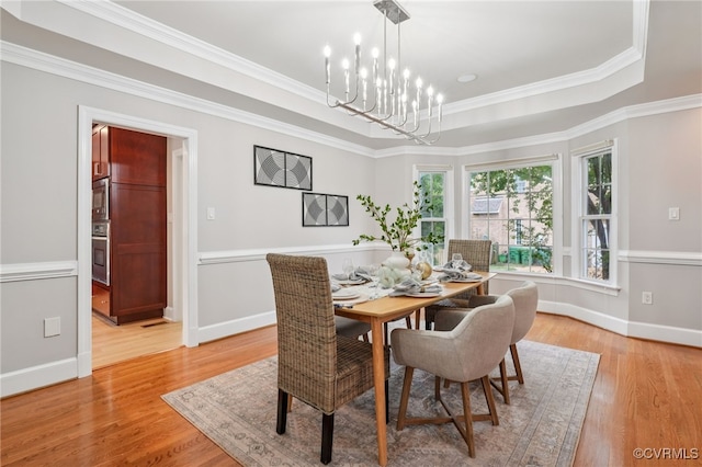 5308 Hillshire Way, Glen Allen, VA 23059 - dining space featuring light wood-style flooring, a chandelier, ornamental molding, and a tray ceiling