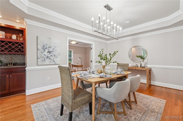 5308 Hillshire Way, Glen Allen, VA 23059 - dining area with a tray ceiling, light wood-style floors, ornamental molding, a chandelier, and bar area
