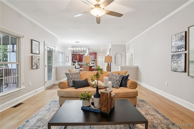 5308 Hillshire Way, Glen Allen, VA 23059 - living area featuring crown molding, plenty of natural light, light wood-style floors, a ceiling fan, and a chandelier