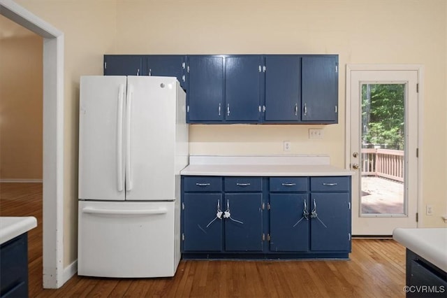 3201 Barnes Spring Ct, Chesterfield, VA 23112 - kitchen with freestanding refrigerator, blue cabinetry, dark wood-style floors, light countertops, and baseboards
