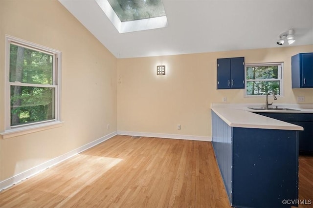3201 Barnes Spring Ct, Chesterfield, VA 23112 - unfurnished living room with a sink, vaulted ceiling, a skylight, light wood-style flooring, and healthy amount of natural light