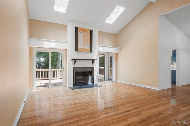 3201 Barnes Spring Ct, Chesterfield, VA 23112 - unfurnished living room with a skylight, high vaulted ceiling, wood finished floors, a high end fireplace, and baseboards