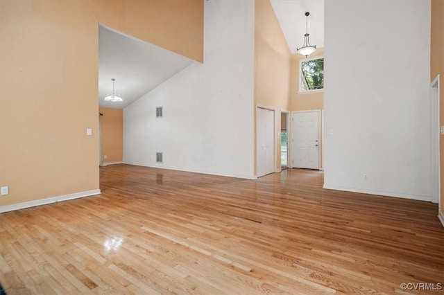 3201 Barnes Spring Ct, Chesterfield, VA 23112 - unfurnished living room with high vaulted ceiling, wood finished floors, a chandelier, and baseboards