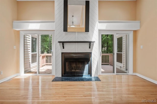 3201 Barnes Spring Ct, Chesterfield, VA 23112 - unfurnished living room featuring wood finished floors, baseboards, a large fireplace, and plenty of natural light