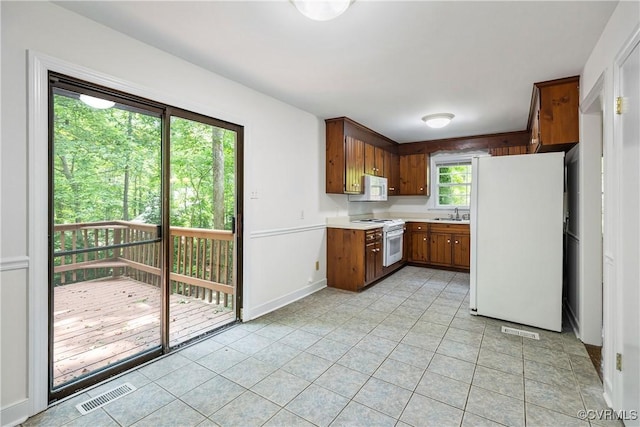 13917 Barnes Spring Rd, Midlothian, VA 23112 - kitchen with white appliances, light countertops, light tile patterned floors, and a sink