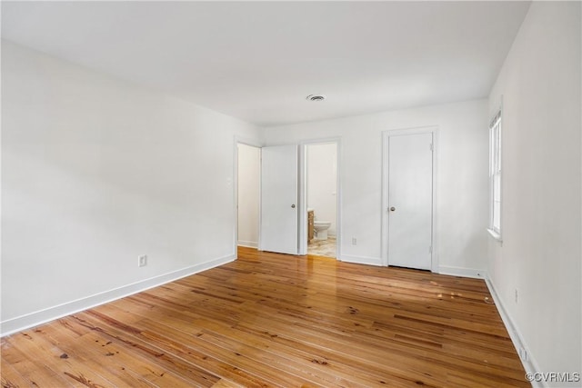 13917 Barnes Spring Rd, Midlothian, VA 23112 - unfurnished bedroom featuring light wood finished floors, baseboards, and connected bathroom