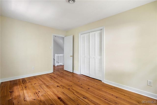 13917 Barnes Spring Rd, Midlothian, VA 23112 - unfurnished bedroom featuring baseboards, a closet, and hardwood / wood-style flooring