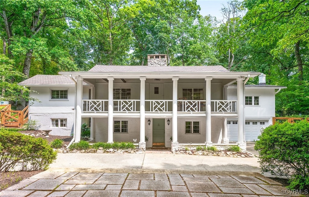 4103 Beechmont Rd, Richmond, VA 23235 - rear view of house with a balcony, a chimney, stucco siding, and covered porch