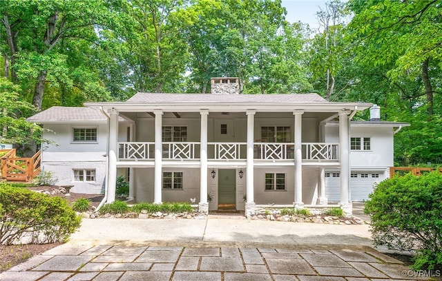 4103 Beechmont Rd, Richmond, VA 23235 - rear view of house with a balcony, a chimney, stucco siding, and covered porch