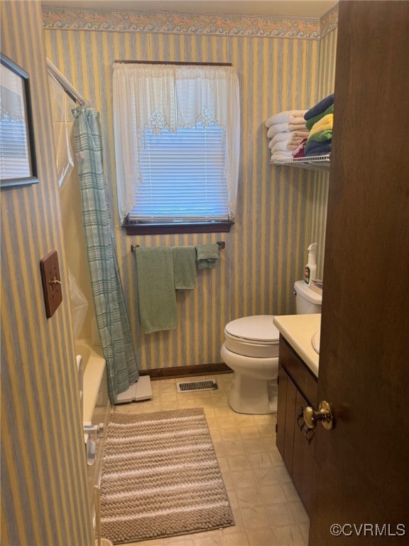 11420 Willow Ln, Disputanta, VA 23842 - full bathroom featuring wallpapered walls, vanity, toilet, and shower / bathtub combination with curtain