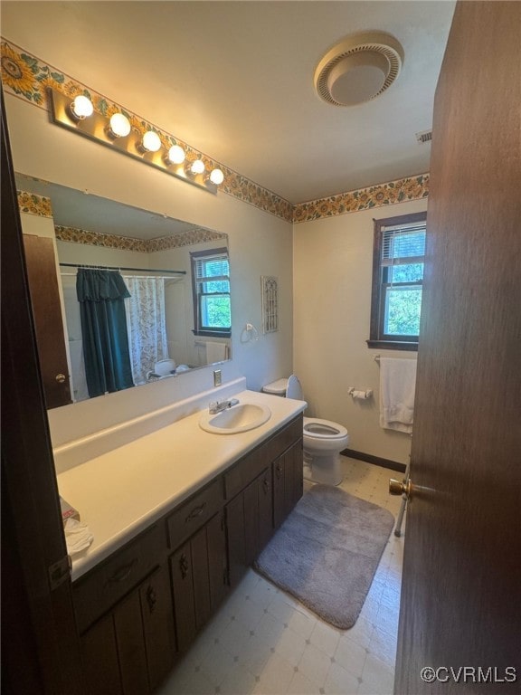 11420 Willow Ln, Disputanta, VA 23842 - full bath with toilet, vanity, a shower with shower curtain, and tile patterned floors
