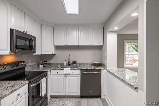 102 Hargrave Ave, Colonial Heights, VA 23834 - kitchen with stainless steel appliances, white cabinetry, and light stone countertops