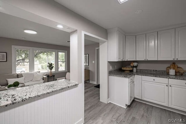 102 Hargrave Ave, Colonial Heights, VA 23834 - kitchen with white cabinets, light wood finished floors, light stone countertops, and open floor plan