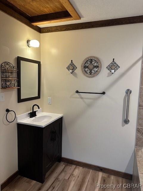 733 Holland Point Rd, Dutton, VA 23050 - bathroom with vanity, wood finished floors, wood ceiling with exposed beams, and baseboards