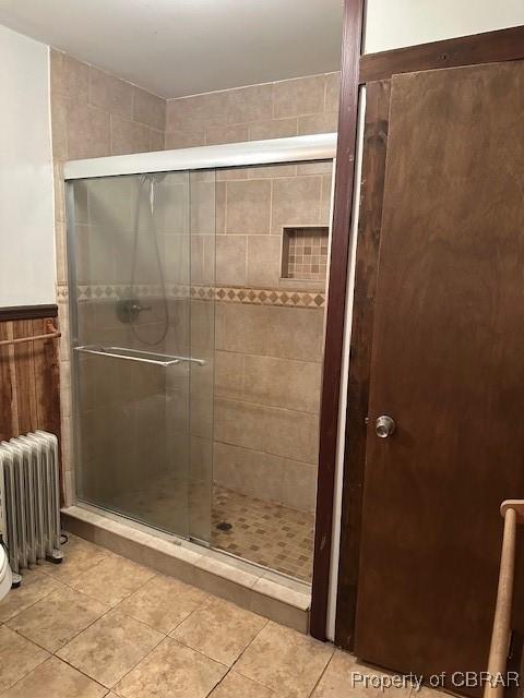 733 Holland Point Rd, Dutton, VA 23050 - full bathroom with radiator, a shower stall, and tile patterned floors