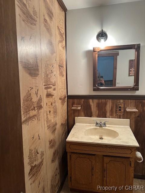 733 Holland Point Rd, Dutton, VA 23050 - bathroom featuring vanity, wooden walls, and a wainscoted wall