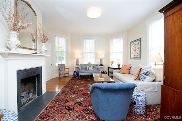 908 High St, Farmville, VA 23901 - living room featuring a fireplace with flush hearth, wood finished floors, and baseboards