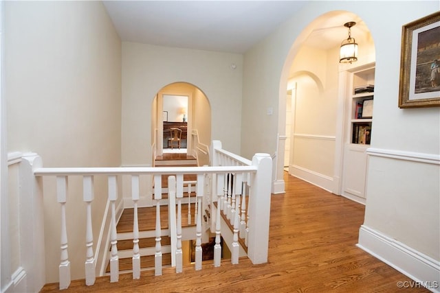 908 High St, Farmville, VA 23901 - corridor featuring wood finished floors, arched walkways, and an upstairs landing