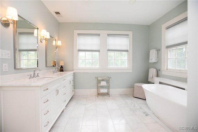908 High St, Farmville, VA 23901 - bathroom with a freestanding bath, marble finish floors, double vanity, and baseboards