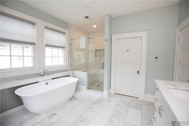 908 High St, Farmville, VA 23901 - bathroom featuring a freestanding bath, a shower stall, vanity, marble look tiles, and recessed lighting