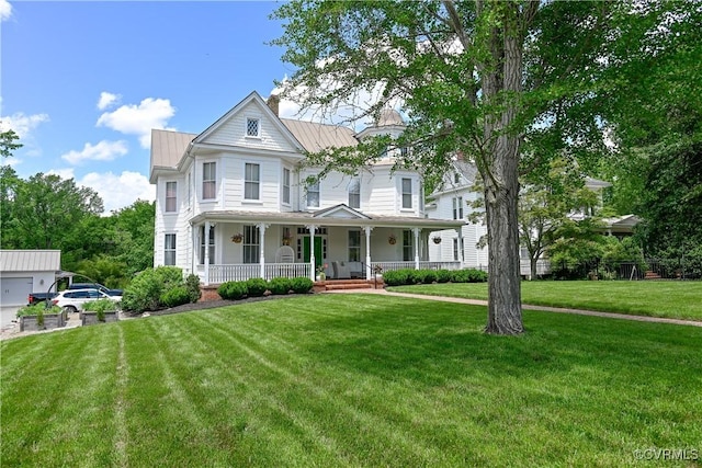 908 High St, Farmville, VA 23901 - victorian-style house with a porch, a front lawn, a chimney, a standing seam roof, and metal roof