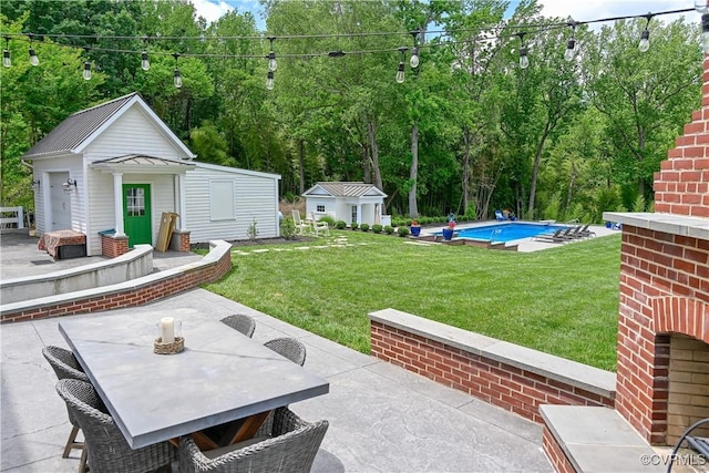908 High St, Farmville, VA 23901 - view of patio with an outdoor pool, outdoor dining area, an outbuilding, and view of scattered trees