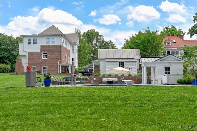 908 High St, Farmville, VA 23901 - back of property with a standing seam roof, a yard, metal roof, and brick siding