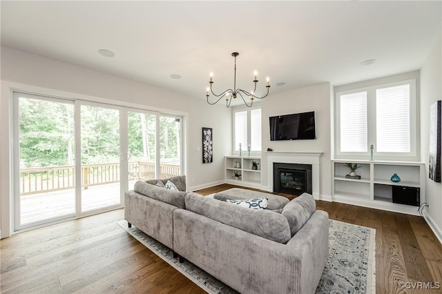 4507 Summer Camp Ct, Moseley, VA 23120 - living room featuring a chandelier, wood finished floors, baseboards, and a glass covered fireplace