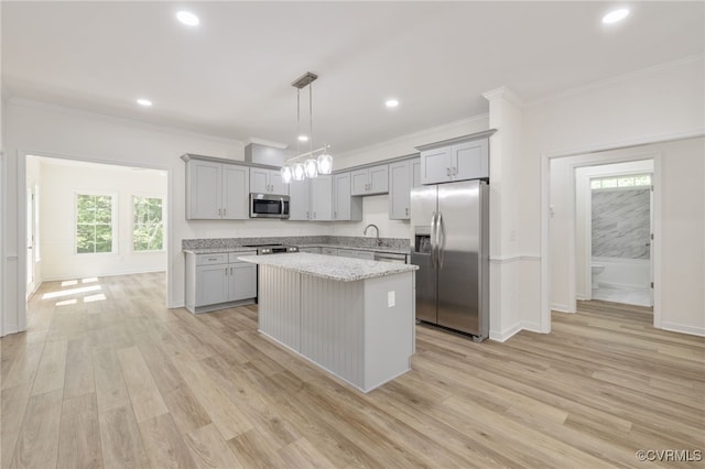 11800 Shady Ln, Chesterfield, VA 23831 - kitchen with appliances with stainless steel finishes, gray cabinetry, a kitchen island, ornamental molding, and light wood finished floors