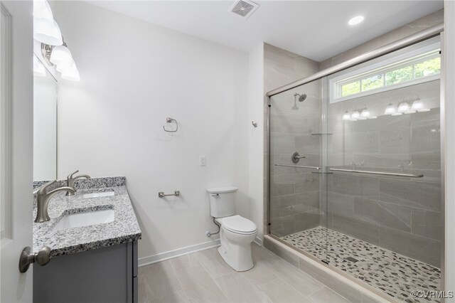 11800 Shady Ln, Chesterfield, VA 23831 - bathroom with toilet, double vanity, baseboards, and a stall shower