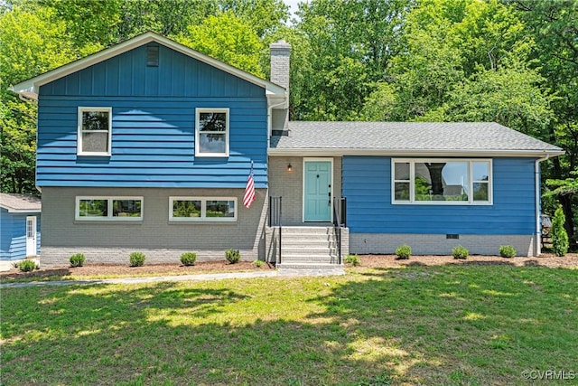 713 Chapman St, Ashland, VA 23005 - split level home featuring a front yard and a chimney