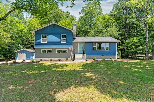713 Chapman St, Ashland, VA 23005 - split level home with an outbuilding, a front yard, a chimney, and a garage