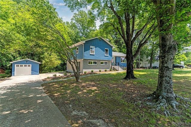 713 Chapman St, Ashland, VA 23005 - split level home with asphalt driveway, an outbuilding, a garage, and board and batten siding